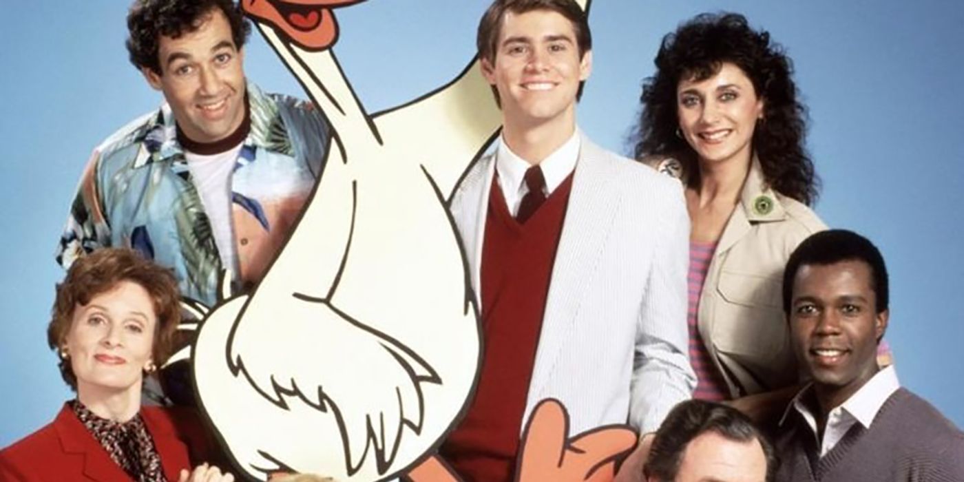 Three men and two women pose with a carton drawn duck in The Duck Factory.