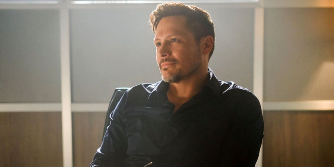 Nick Wechsler as Oliver Odell sitting in a chair while looking at someone to the right in The Hunting Party
