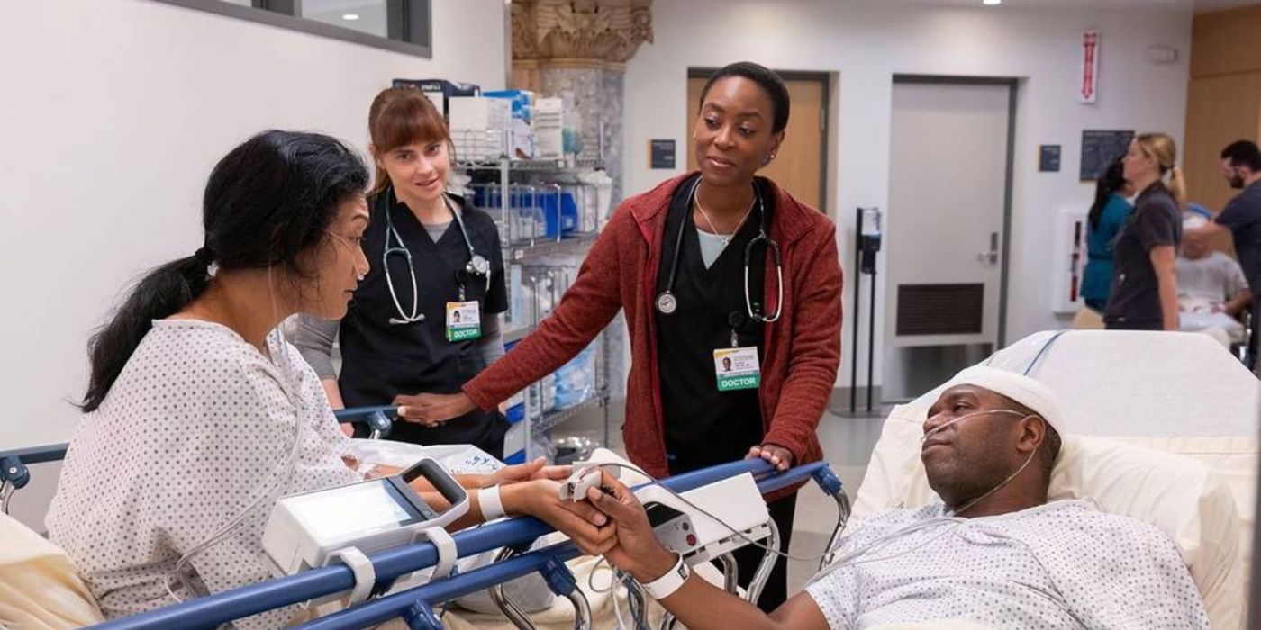 Heather Collins (Tracy Ifeachor) and Cassie McKay (Fiona Dourif) smiling with two patients in The Pitt.