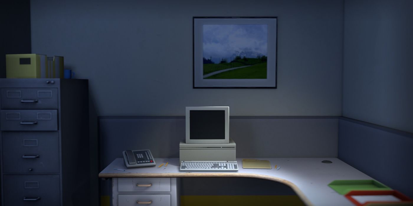 A computer sitting atop a desk in a dark office in the game The Stanley Parable.