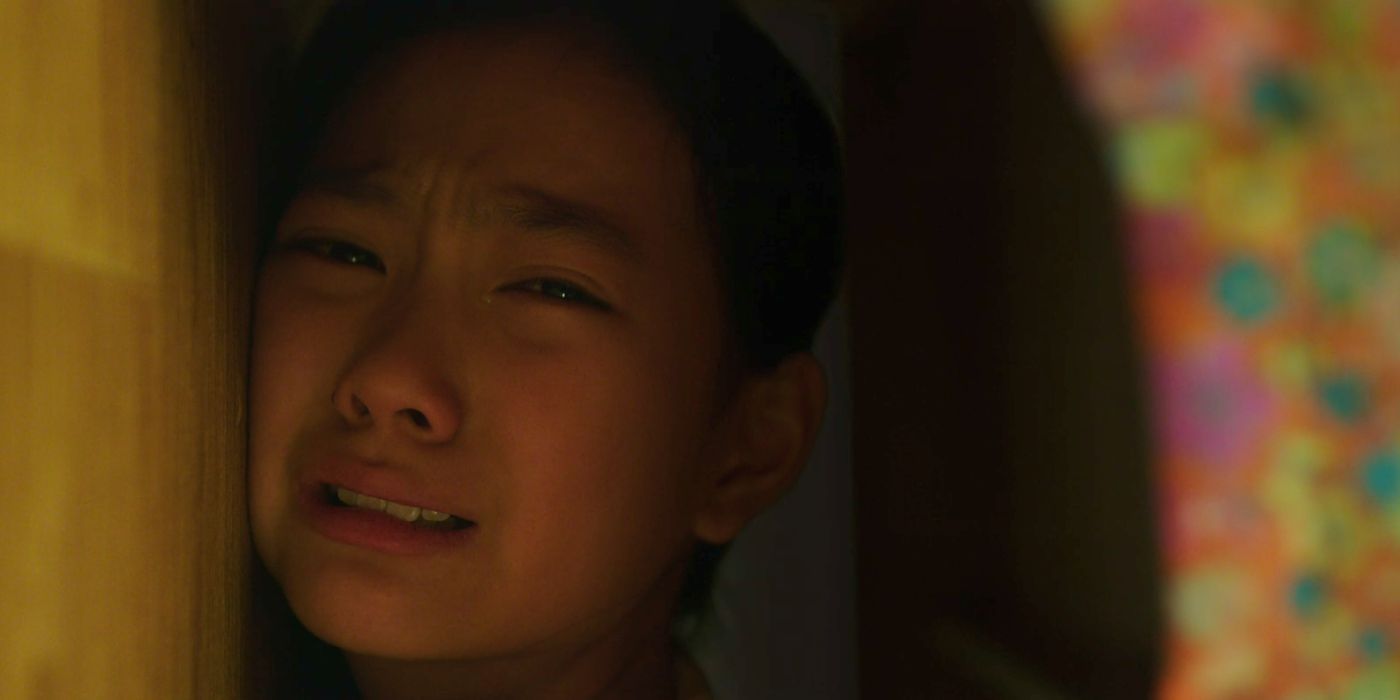Young Sook-hee hides under her bed as her father is attacked in The Villainess