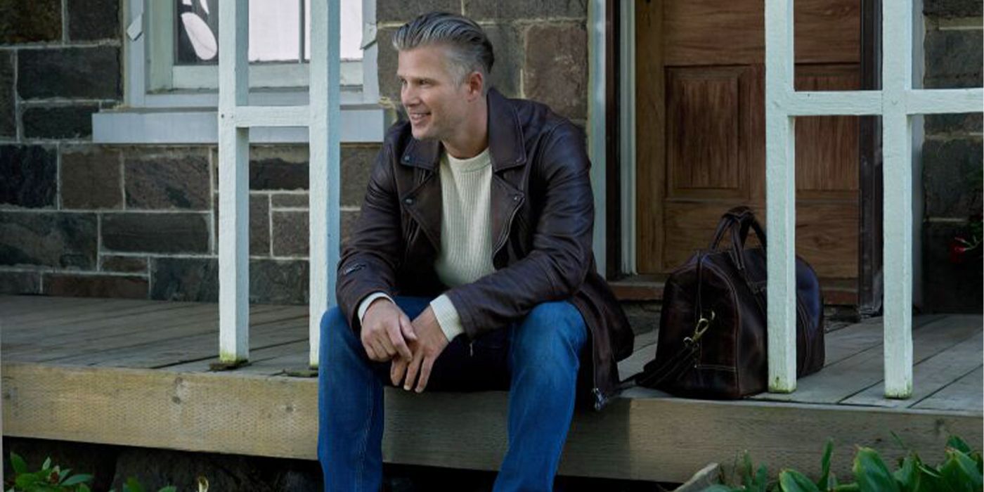 Nick sitting on porch steps smiling in The Way Home Season 3
