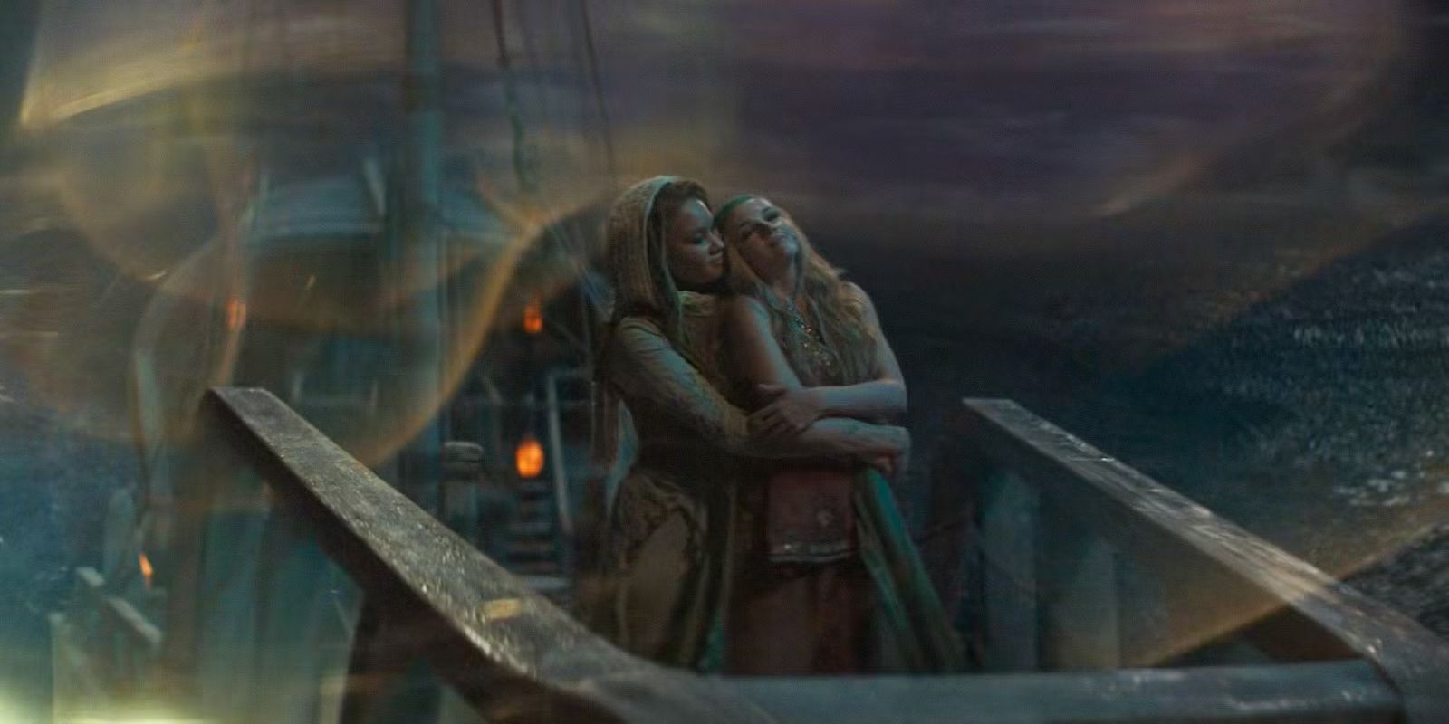Elayne (Ceara Coveney) and Aviendha (Ayoola Smart) embracing on a Sea Folk ship in Elayne&rsquo;s dream in The Wheel of Time Season 3