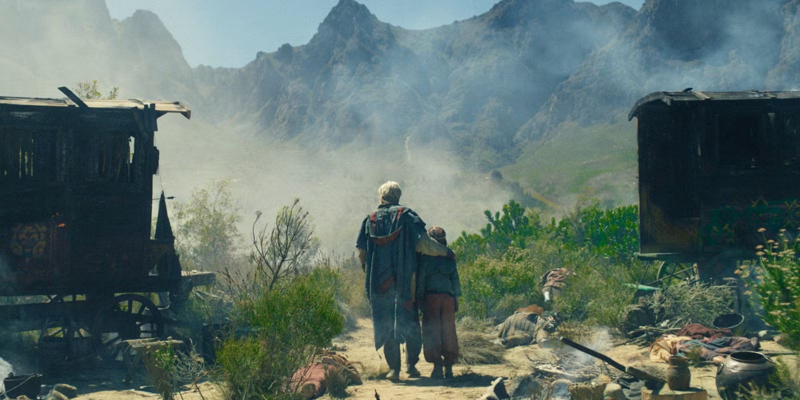 Jonai (Josha Stradowski) holding his grandson Adan (Atom Uniacke) in The Wheel of Time Season 3 Episode 4.