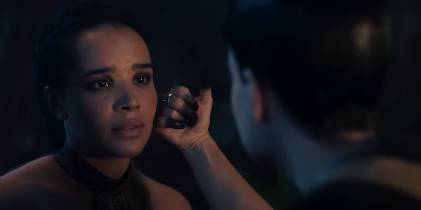 Laia Costa touching Zoe Robins' face with blackened fingers