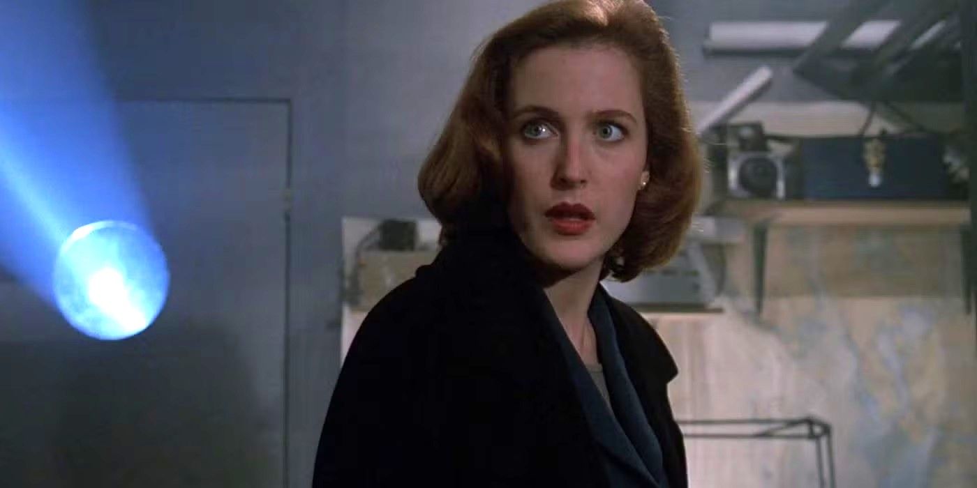 Agent Scully looks slightly worried at something off-camera in The X-Files.