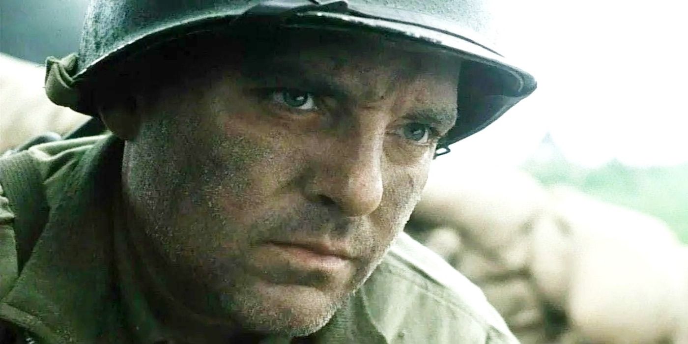 Tom Sizemore in military clothing and a helmet looks serious in Saving Private Ryan.