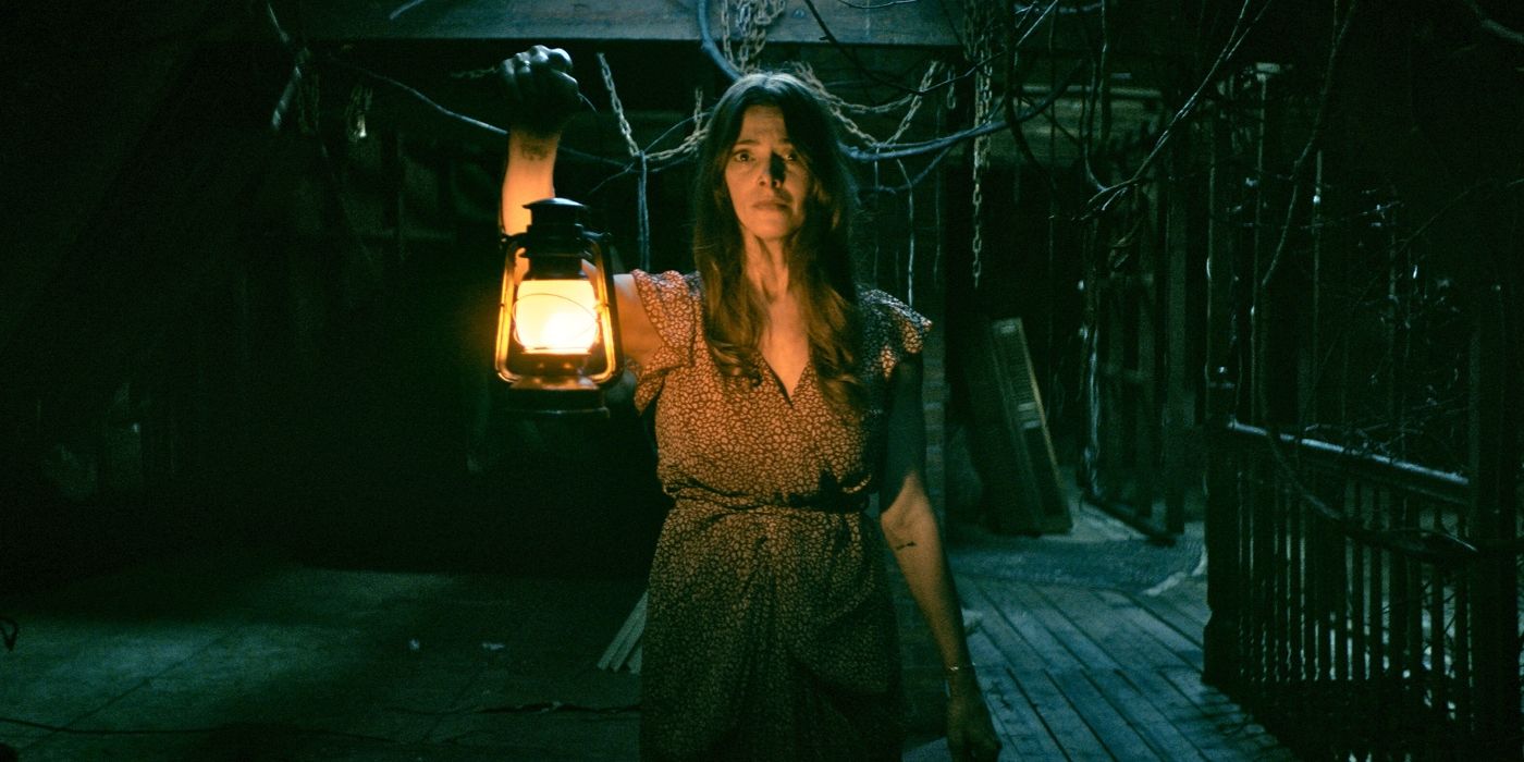 Ashely Greene holds a lantern in It Feeds