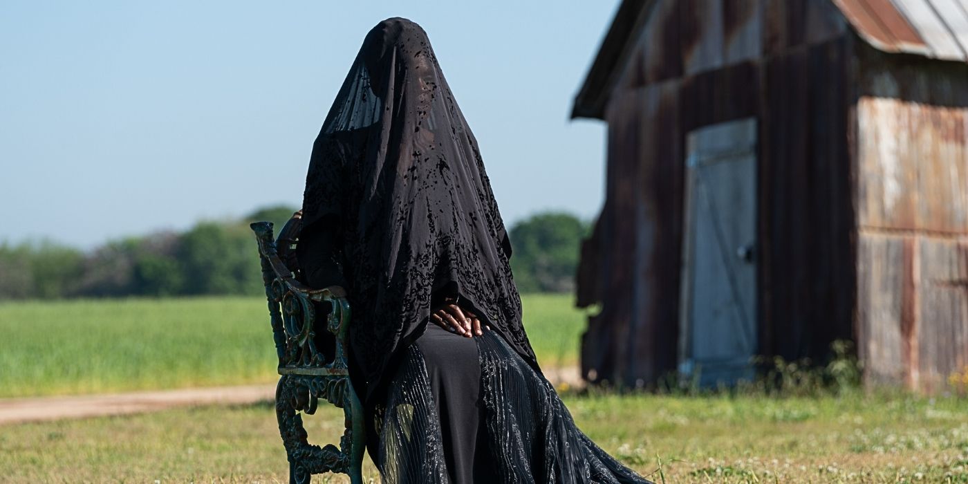 A woman draped in a black veil from The Woman in the Yard