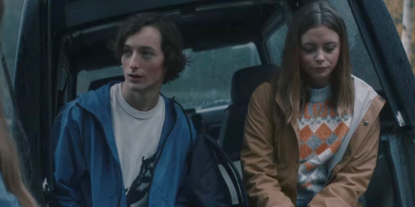 Elli Rhiannon Müller Osborne sitting in the open trunk area of an SUV next to Sjur Vatne Brean in Viking Wolf.