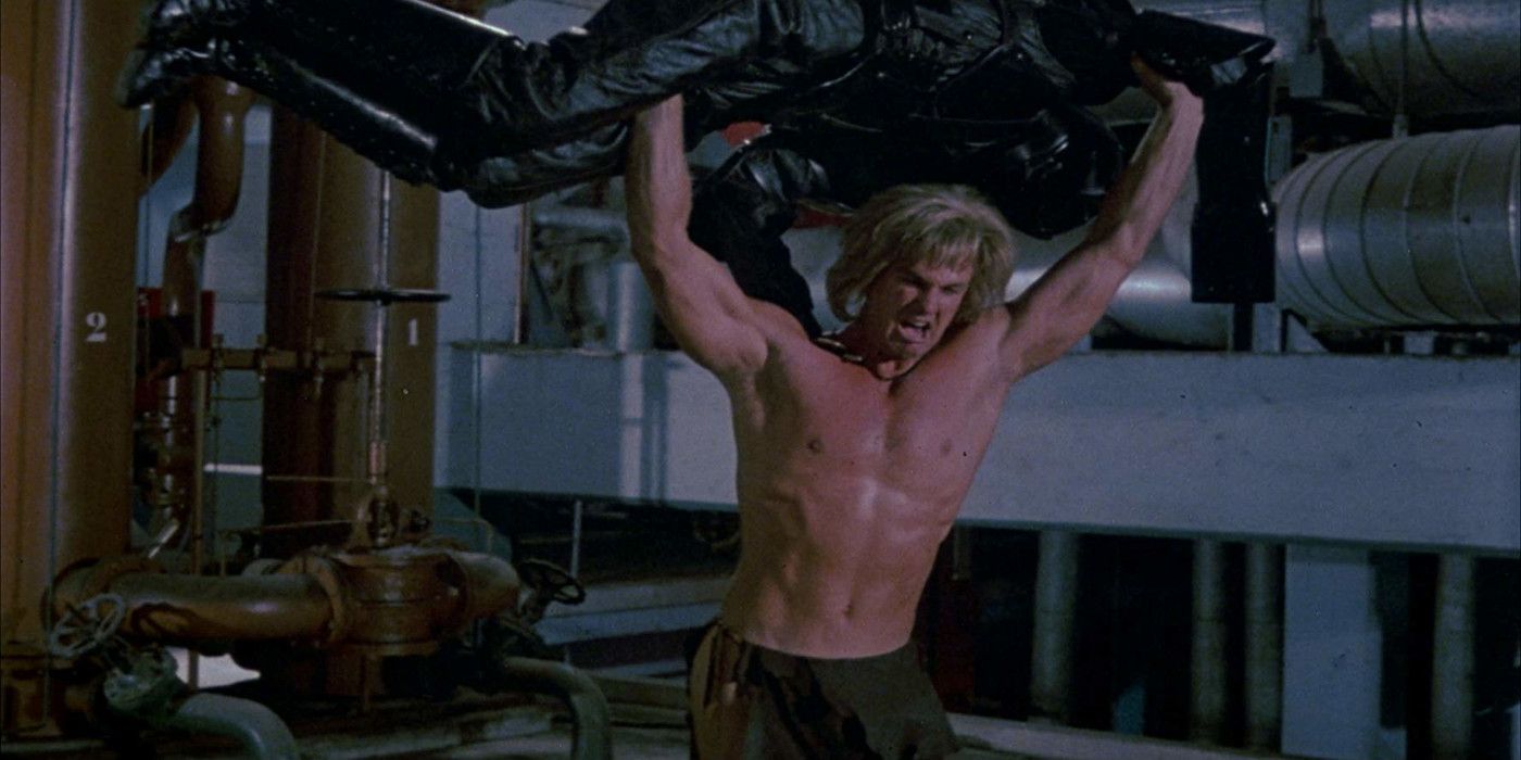 Yor holds an enemy&rsquo;s body over his head in Yor, the Hunter From the Future.