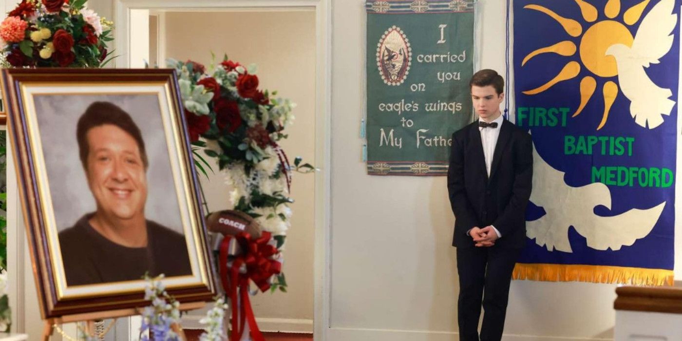 Sheldon stands against the wall at George's funeral in Young Sheldon