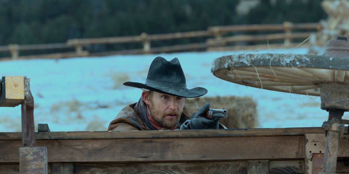 Brian Geraghty shooting from behind a wagon
