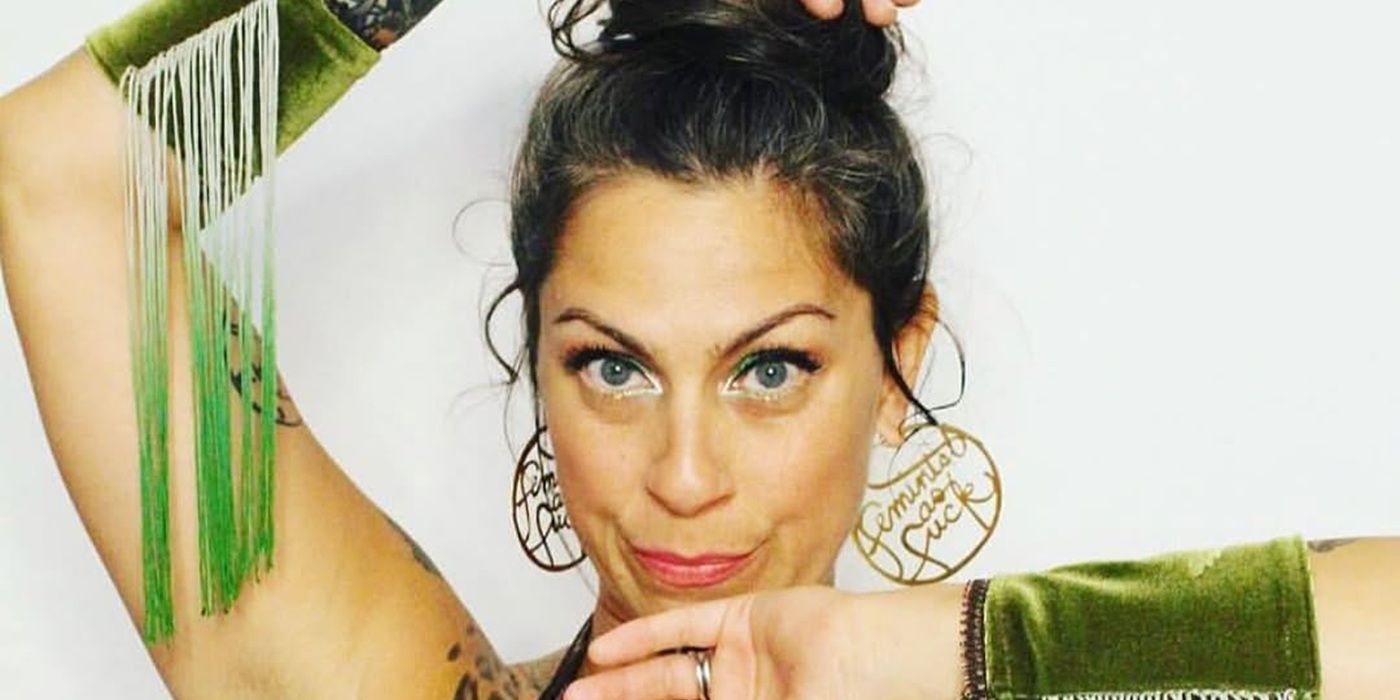 Danielle Colby posing for a photo in a green dress