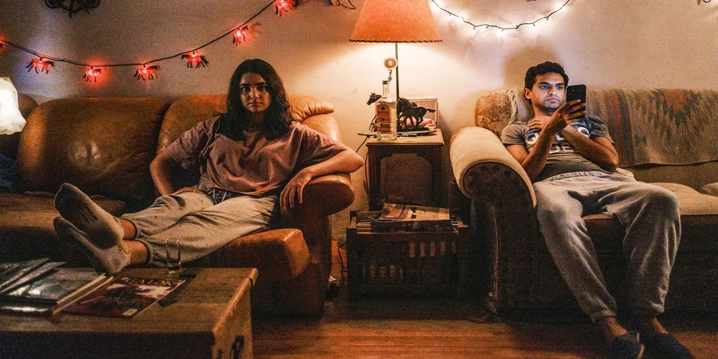 Geraldine Viswanathan and Karan Soni lounge on separate couches with string lights on the walls in 7 Days.