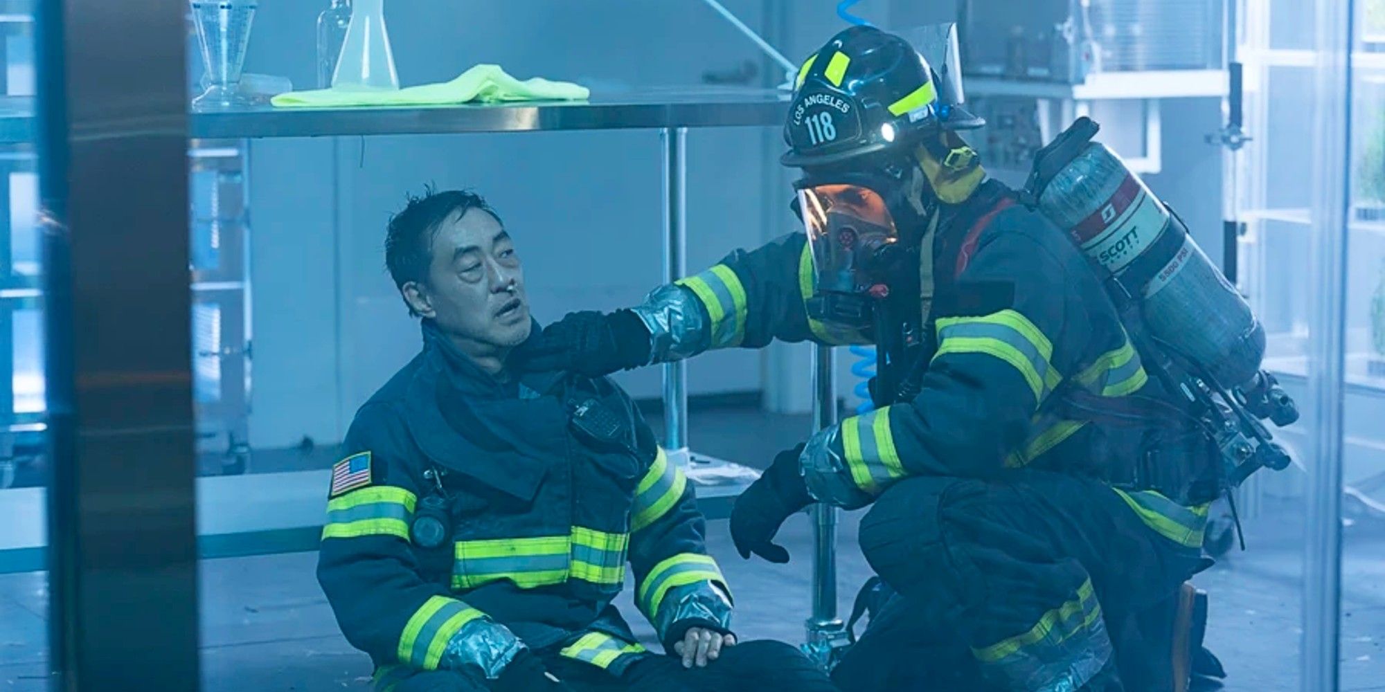 Ravi Panikkar in full firefighting gear treating a sick and unmasked Chimney while stuck in a lab in 9-1-1 Season 8