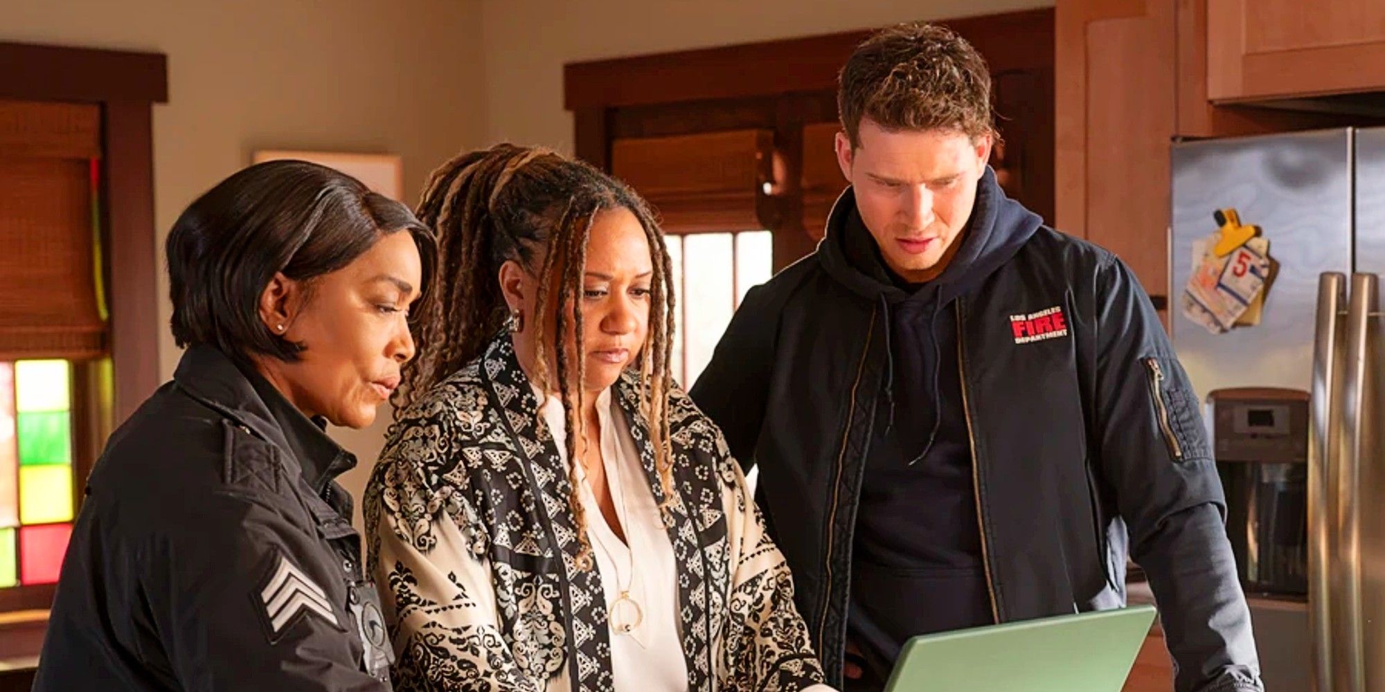 Athena Grant, Karen Wilson, and Buck crowded around a laptop in 9-1-1 Season 8