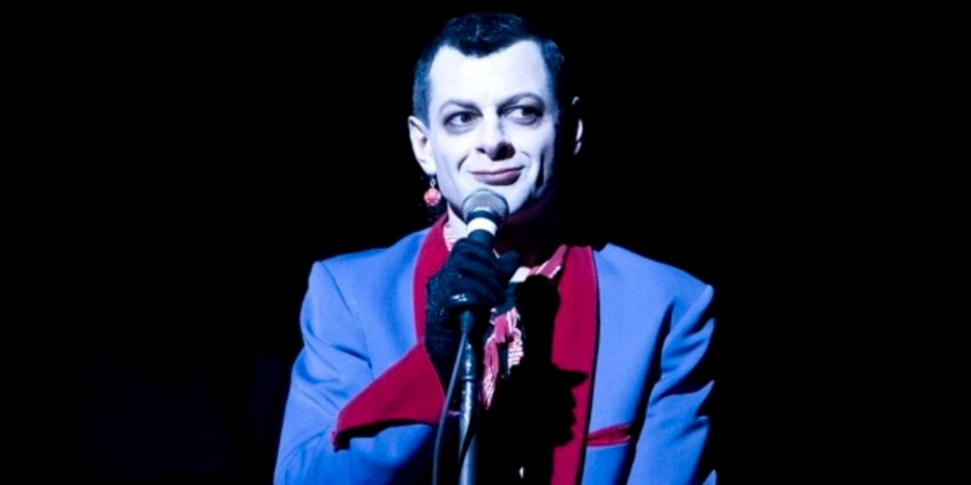 Andy Serkis as Ian Dury on stage in a multicolored suit in &lsquo;Sex &amp; Drugs &amp; Rock &amp; Roll&rsquo;.