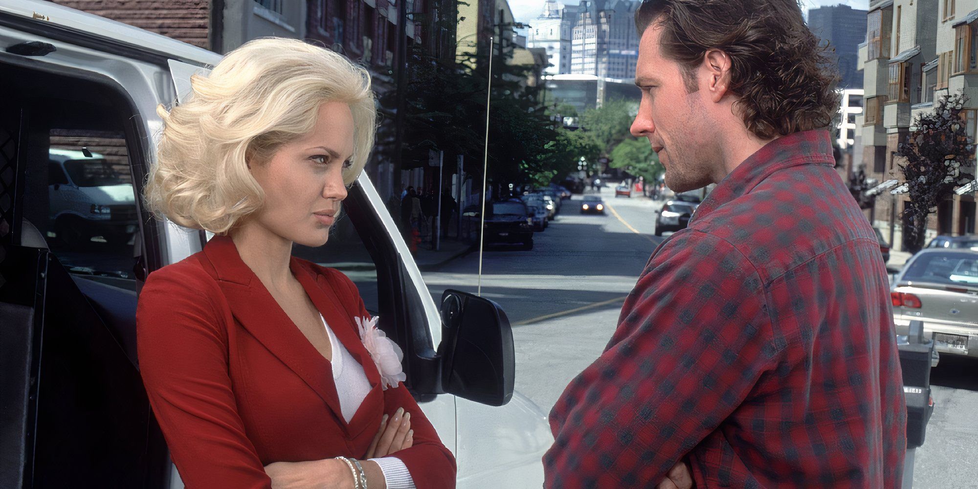 Angelina Jolie as Lanie and Edward Burns as Pete in Life or Something Like It looking at each other with crossed arms.