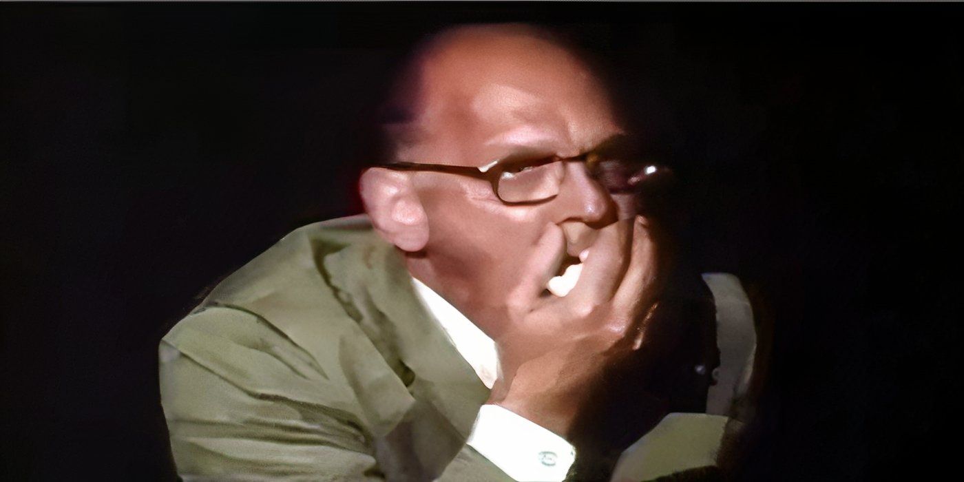 Audience member gagging in horror at a gory movie