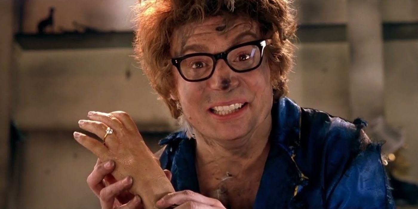 Mike Myers as Austin Powers covered in soot and smoking after being in an explosion while holding a robot hand in &lsquo;Austin Powers: The Spy Who Shagged Me&rsquo; (1999)