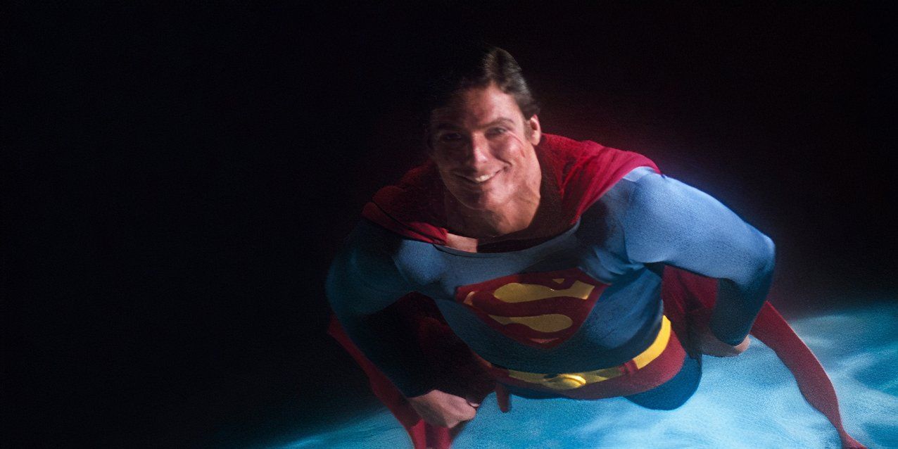 Christopher Reeve, as Superman, smiles and flies through space in Superman