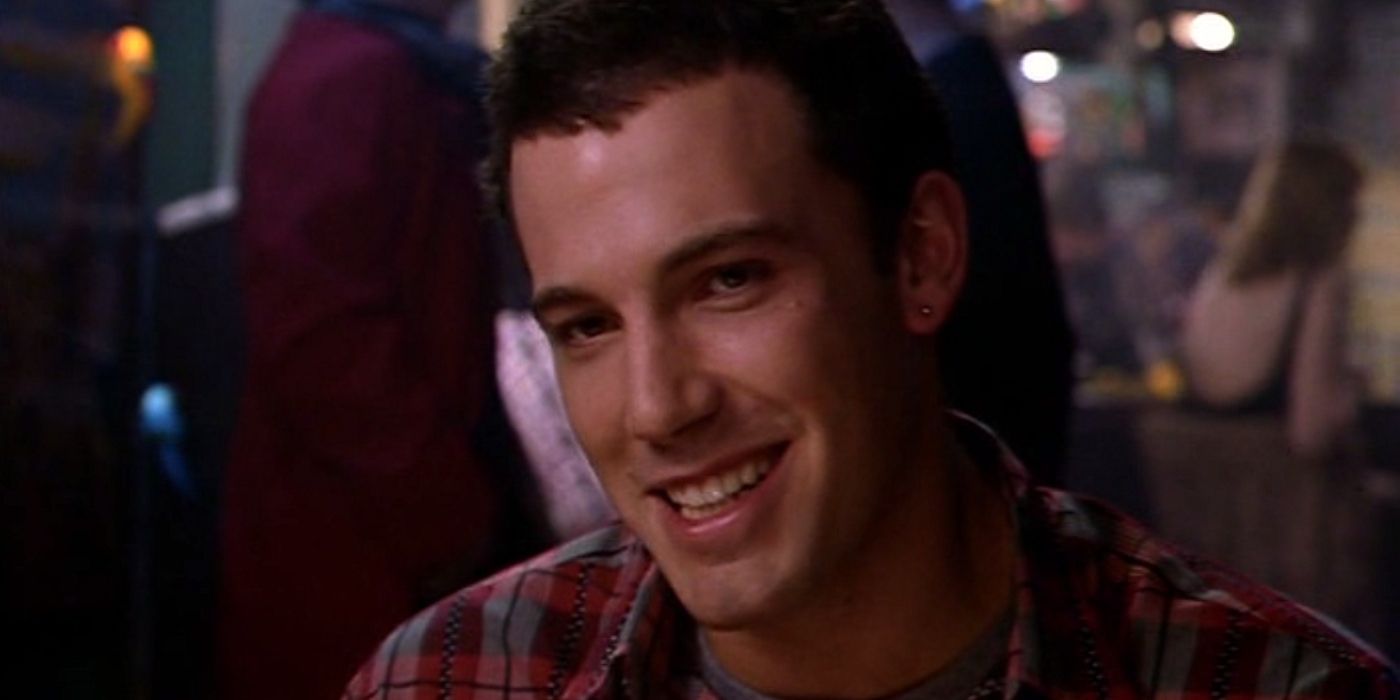 Ben Affleck smiling at someone off-screen as the bartender in 200 Cigarettes
