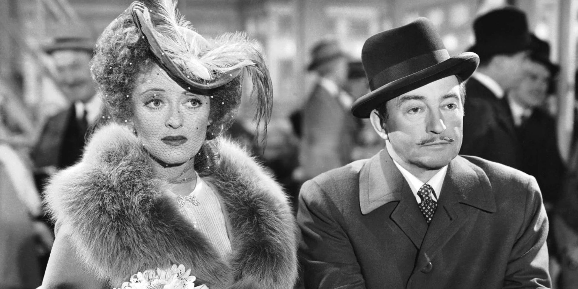 Bette Davis standing beside Claude Rains both looking straight ahead in Mr. Skeffington (1944)
