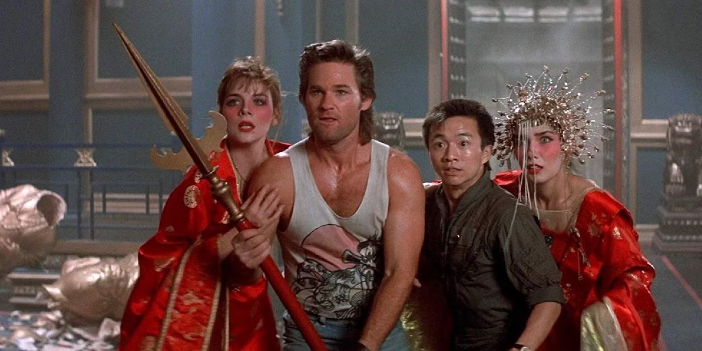 Kurt Russell holds a spear with three people around him in Big Trouble in Little China.