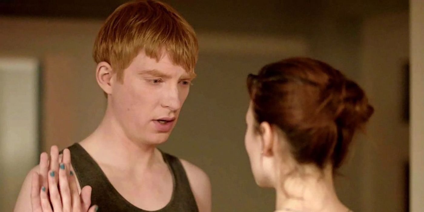 A man in a tank top holds his palm up to a woman in Black Mirror's "Be Right Back" episode