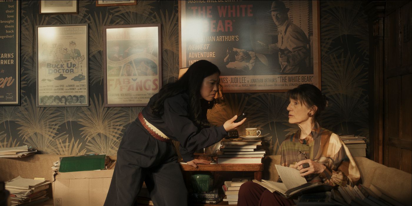 Awkwafina and Harriet Walter talking on speakerphone to someone in Black Mirror Season 7's Hotel Reverie.