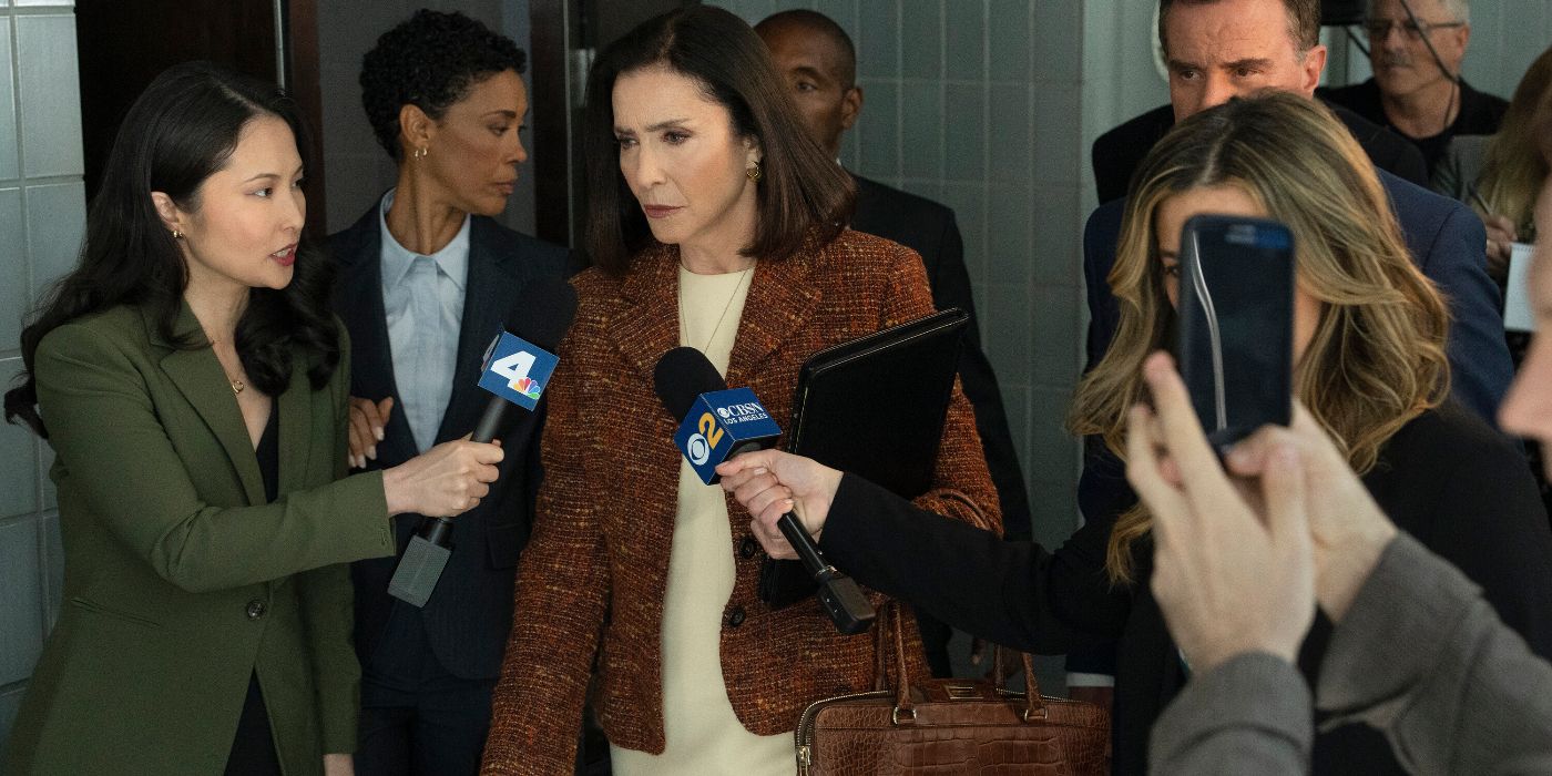 Mimi Rogers walking through a crowd of reporters.