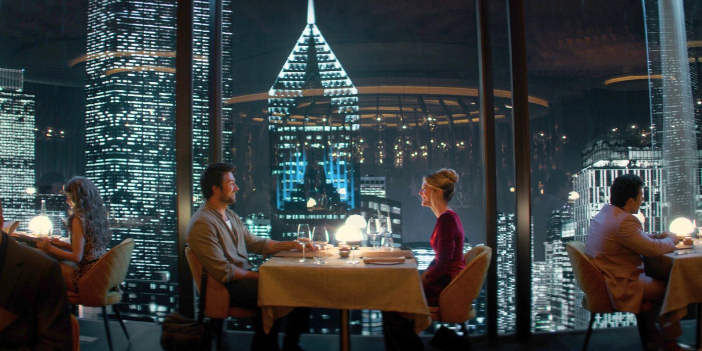 Brandon Sklenar as Henry and Meghann Fahy as Violet sitting at a restaurant table facing the Chicago skyline in Drop.