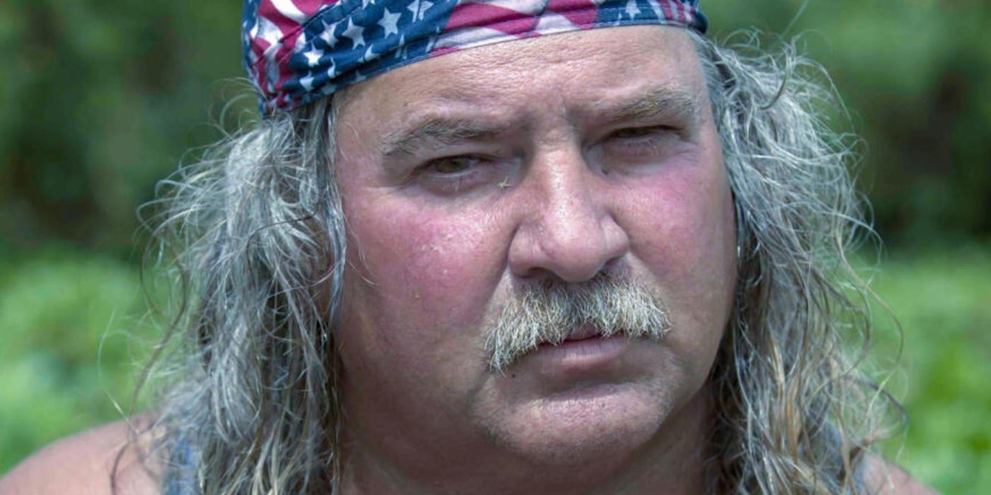 Bruce Mitchell in &lsquo;Swamp People&rsquo; wearing an American Flag bandanna and looking towards the camera.