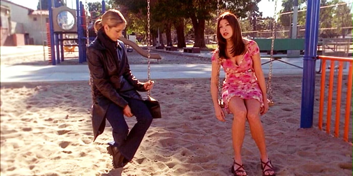 Buffy and April sitting on a park swing set in Buffy the Vampire Slayer.