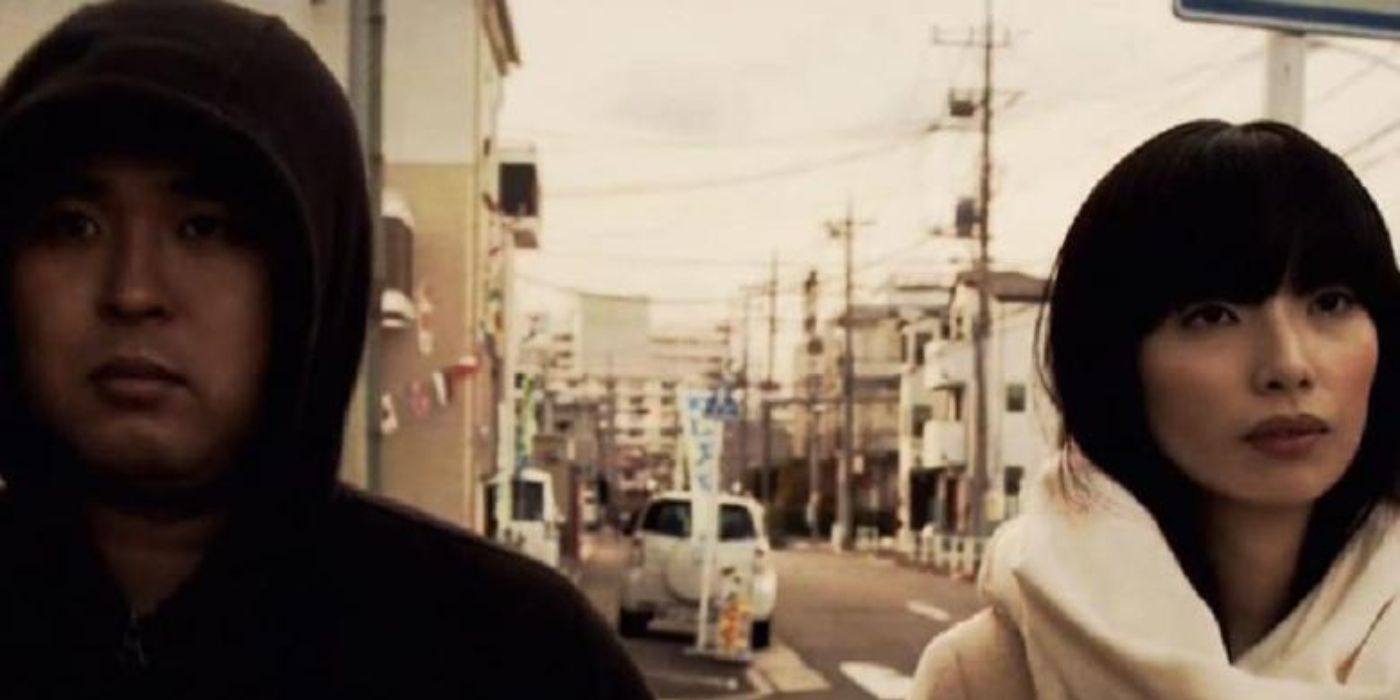 Butch and Asami as Man and Woman in J-horror Brutal, walking down the street in silence