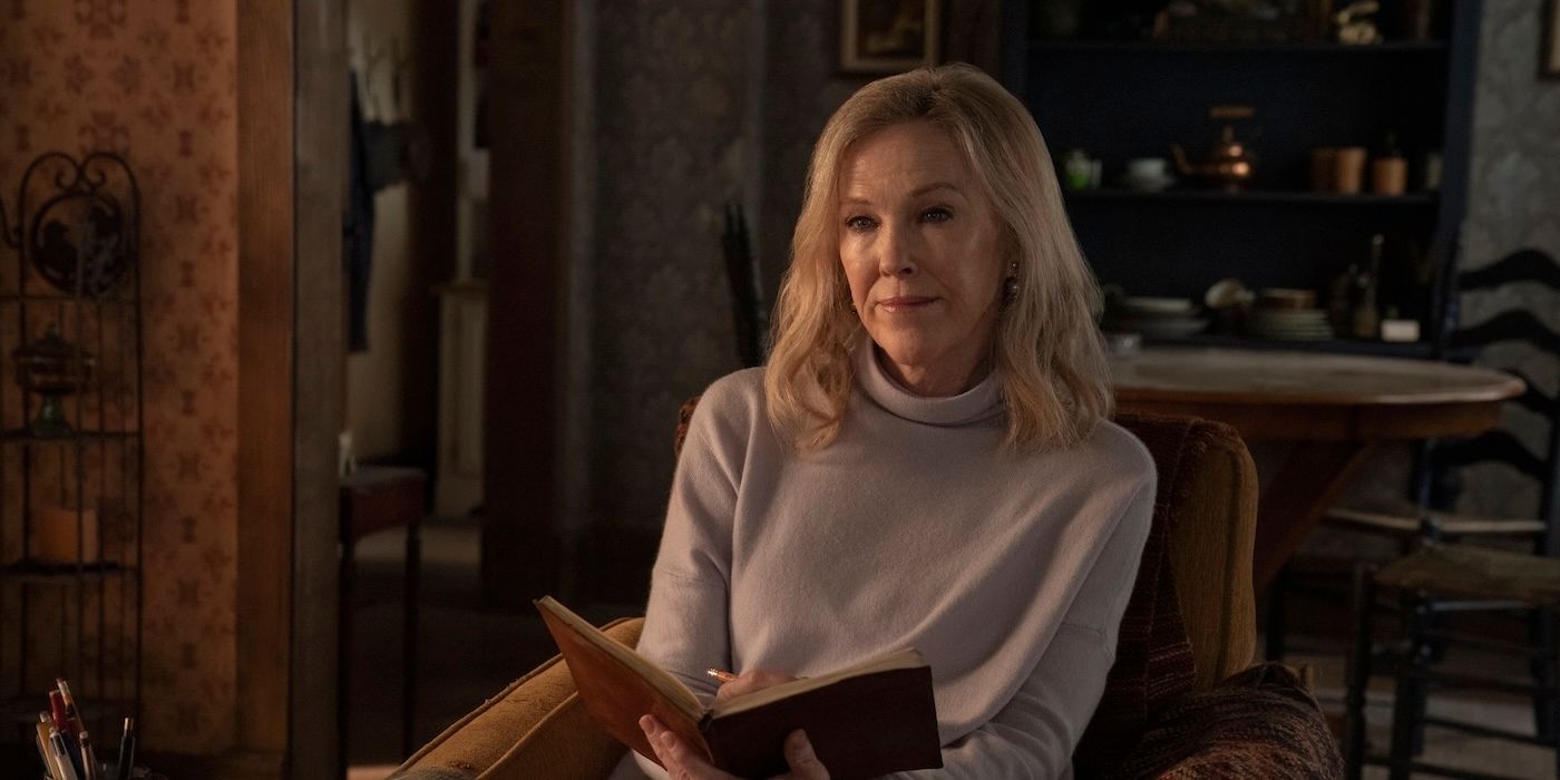 Catherine O'Hara as Gail holding an open book in The Last of Us Season 2.