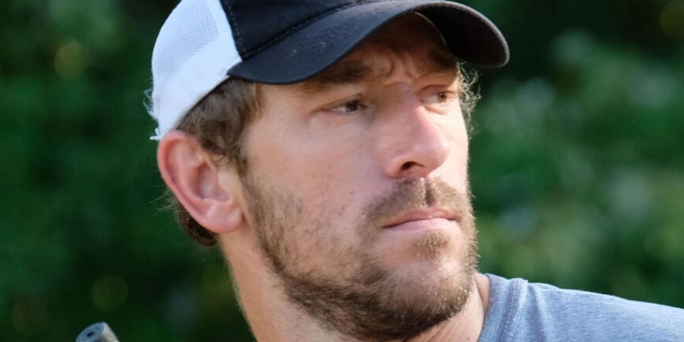 Chase Landry in a baseball cap looking serious on &lsquo;Swamp People&rsquo;.