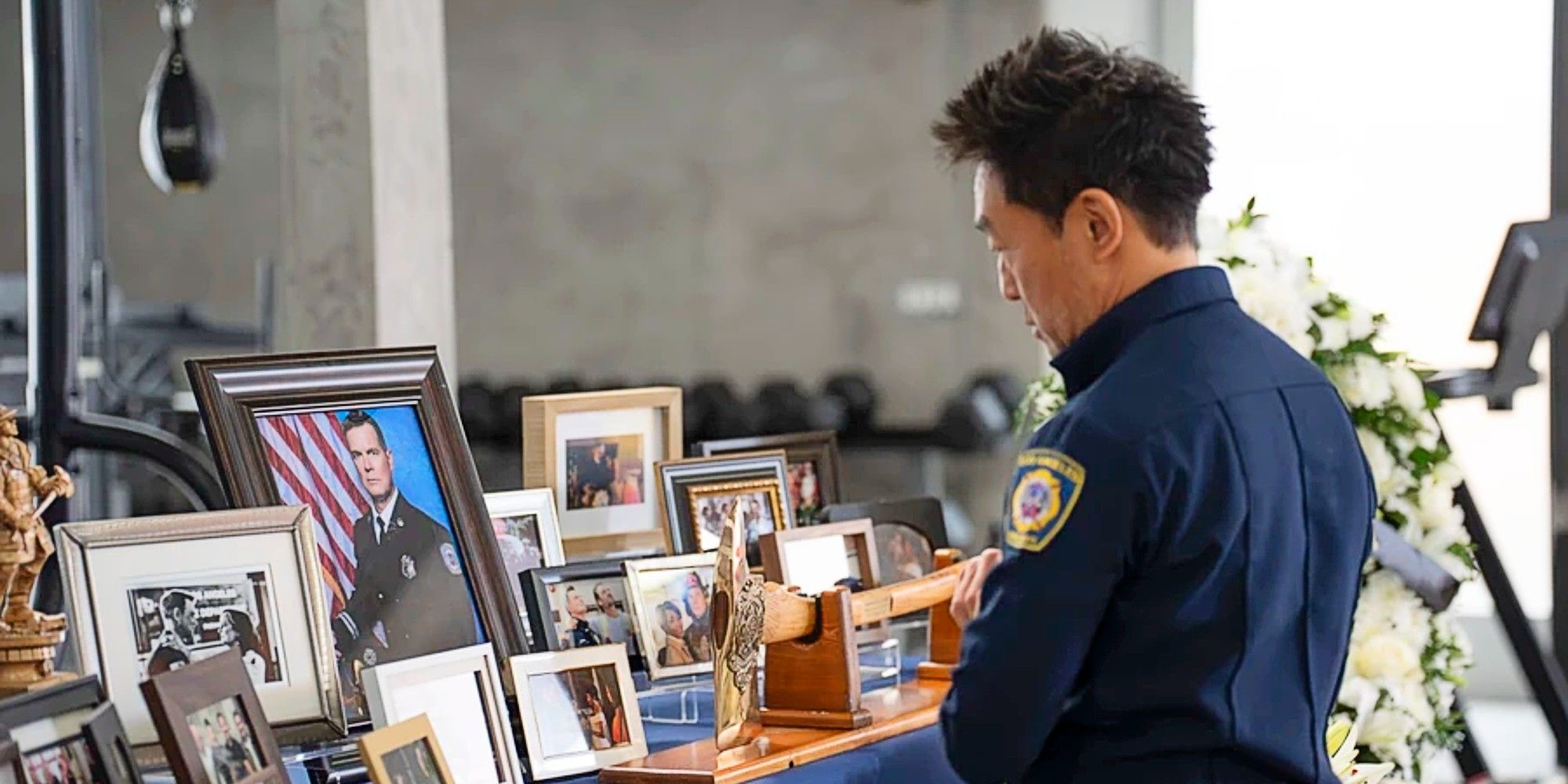Chimney Han standing at Bobby Nash's makeshift memorial in 9-1-1 Season 8