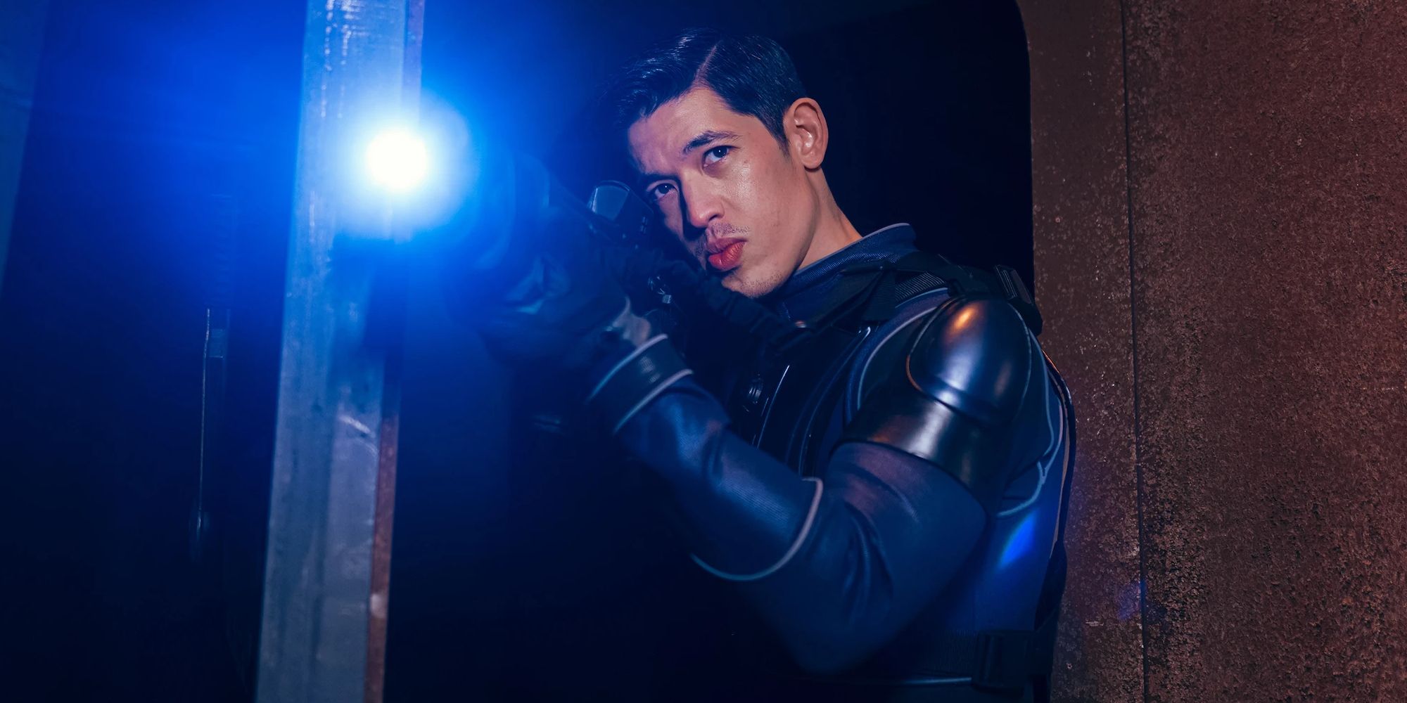christopher chung pointing a blue-lasered sci-fi gun in Doctor Who
