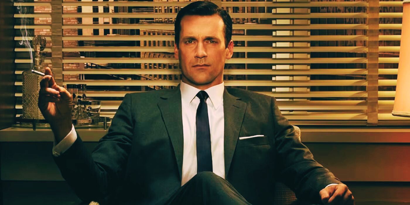 Jon Hamm as Don Draper in 'Mad Men' sitting in a chair in his office with a cigarette in his hand.
