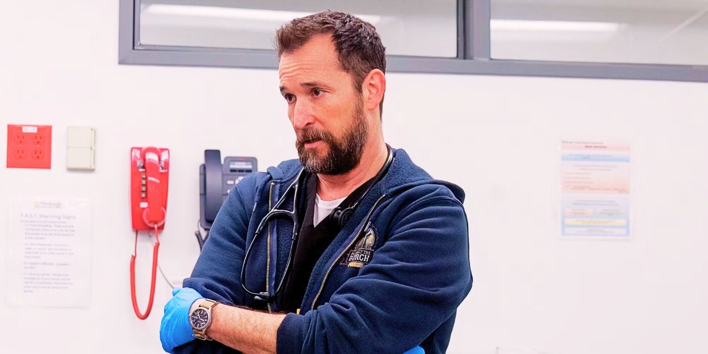 Dr. Robby in The Pitt Season 1 finale standing with his arms folded and looking at something in front of him.