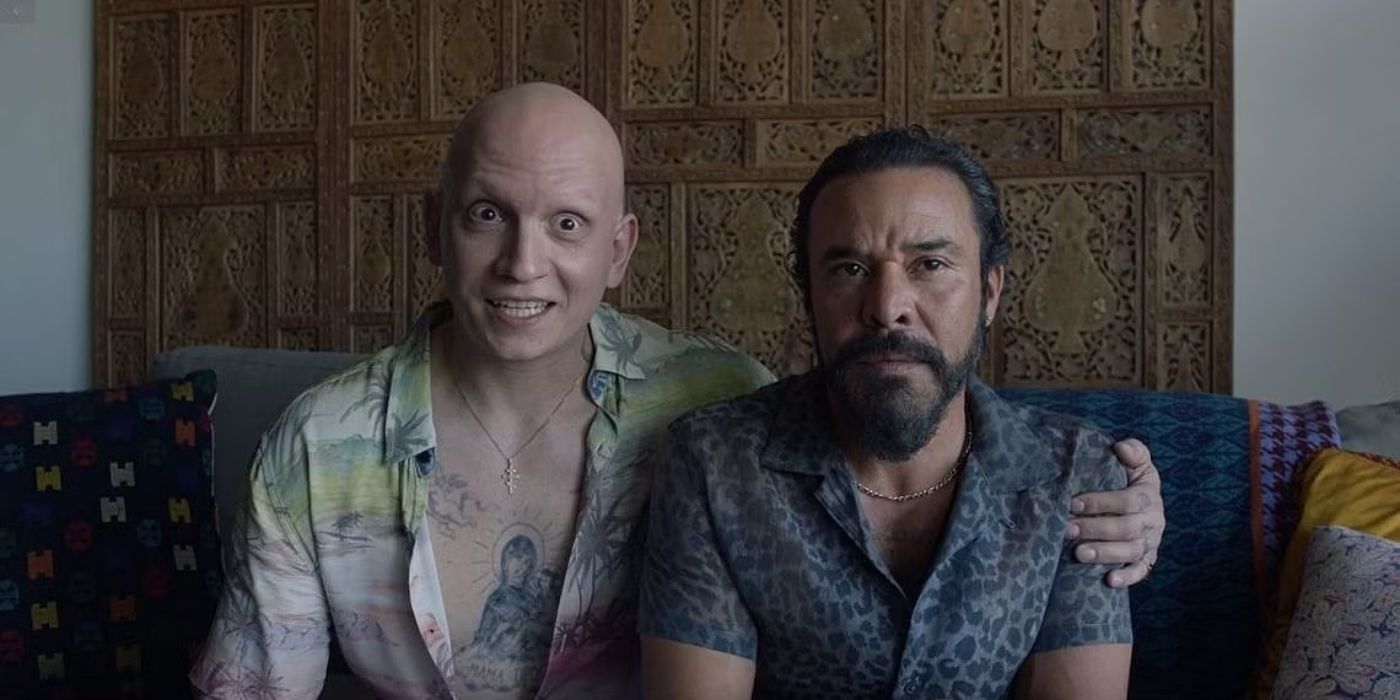 Anthony Carrigan as NoHo Hank sits next to Michael Irby as Cristobal Sifuentes on a couch in Barry.