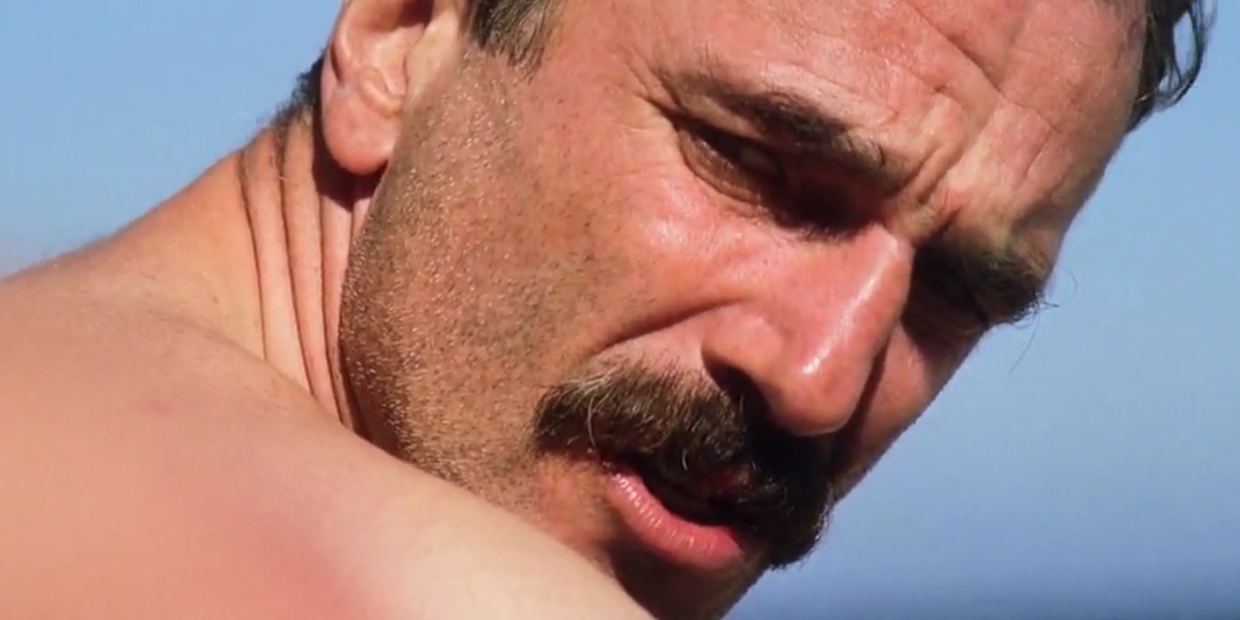 Daniel Plainview looks suspiciously over his shoulder at the beach in There Will Be Blood.