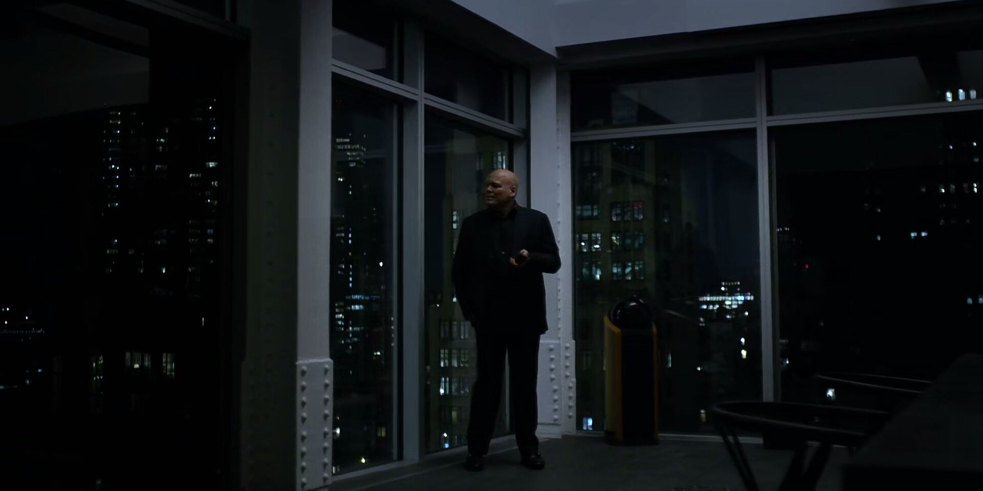 a man standing in front of windows