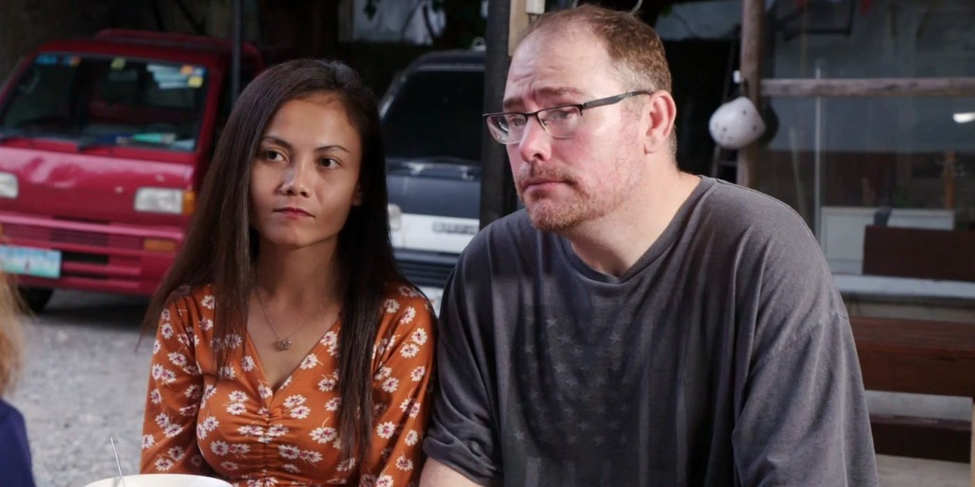 David Dangerfield and Sheila Mangubat at a table looking stressed in 90 Day Fiancé.