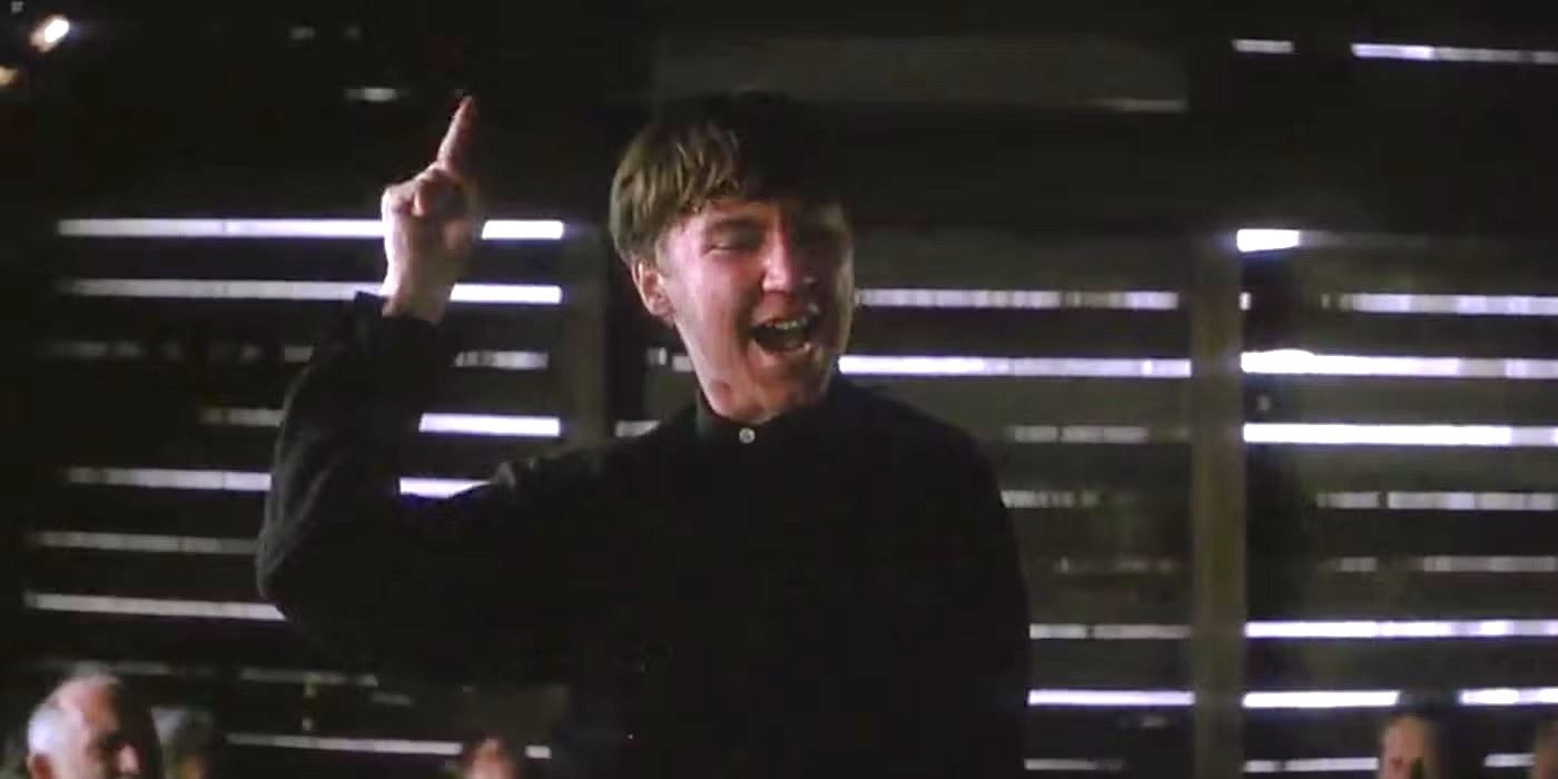 Eli shouts and points at the sky in a decrepit room in There Will Be Blood.