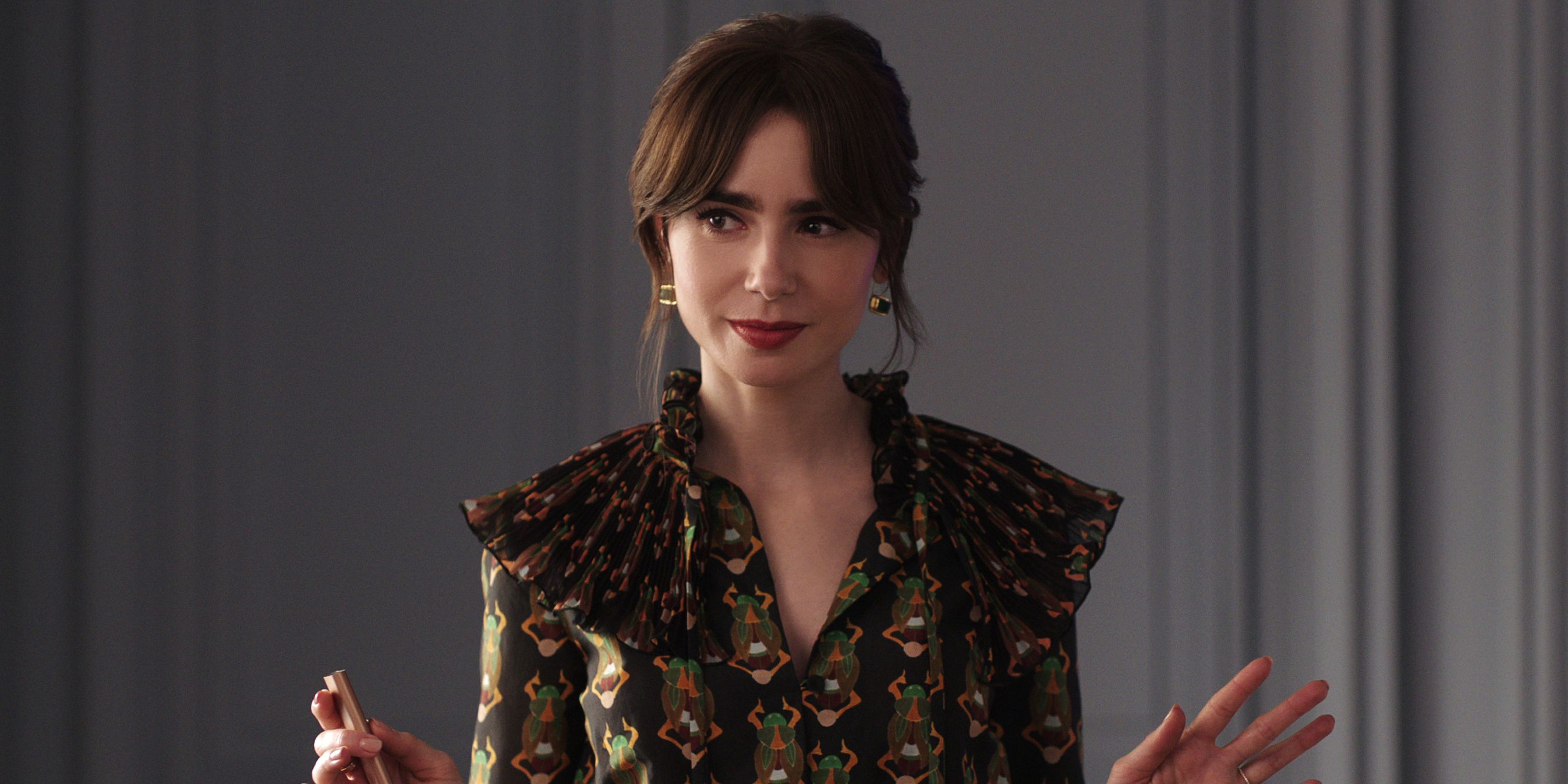 Emily Cooper, played by Lily Collins is presenting at her marketing agency office.