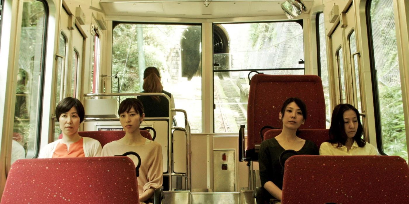 Four women are sitting next to each other on a bus in the Japanese movie Happy-Hour
