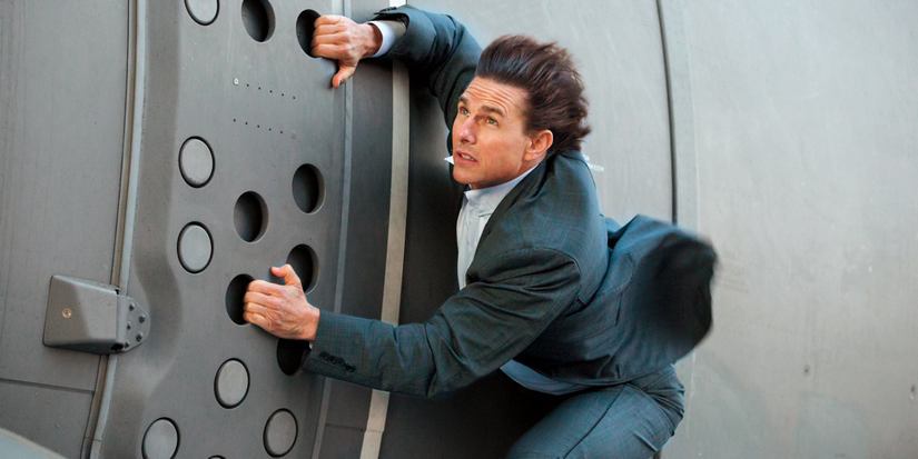 Ethan Hunt hanging from a moving plane in Mission: Impossible - Rogue Nation